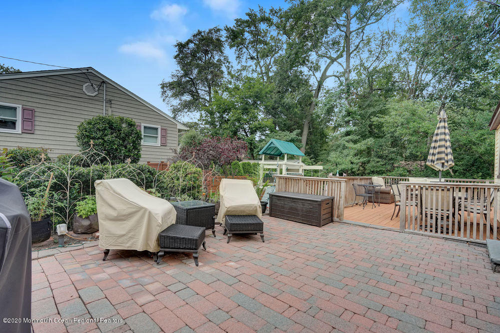 223 Delaware Avenue Oakhurst, NJ 07755 - Photo 19 of 30 a view of a chairs and tables in the back yard of the house