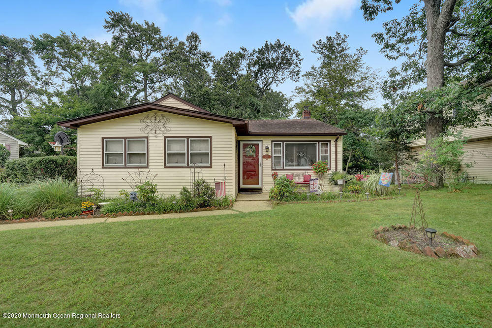 223 Delaware Avenue Oakhurst, NJ 07755 - Photo 2 of 30 a front view of a house with a yard