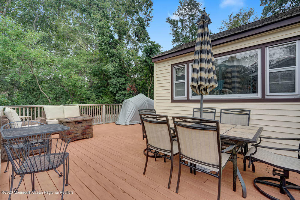 223 Delaware Avenue Oakhurst, NJ 07755 - Photo 23 of 30 a view of a chairs and table on the deck