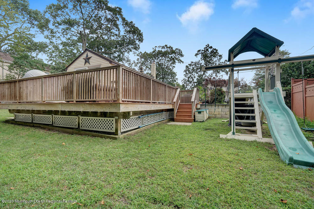 223 Delaware Avenue Oakhurst, NJ 07755 - Photo 26 of 30 a view of a backyard with a small cabin and wooden fence
