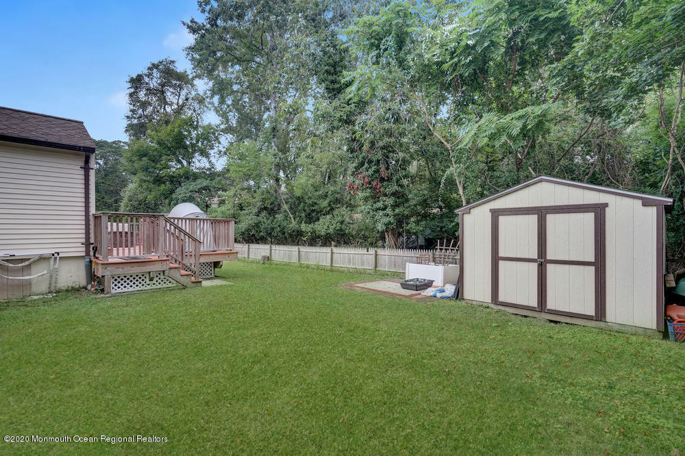 223 Delaware Avenue Oakhurst, NJ 07755 - Photo 27 of 30 a view of backyard with a garden and deck