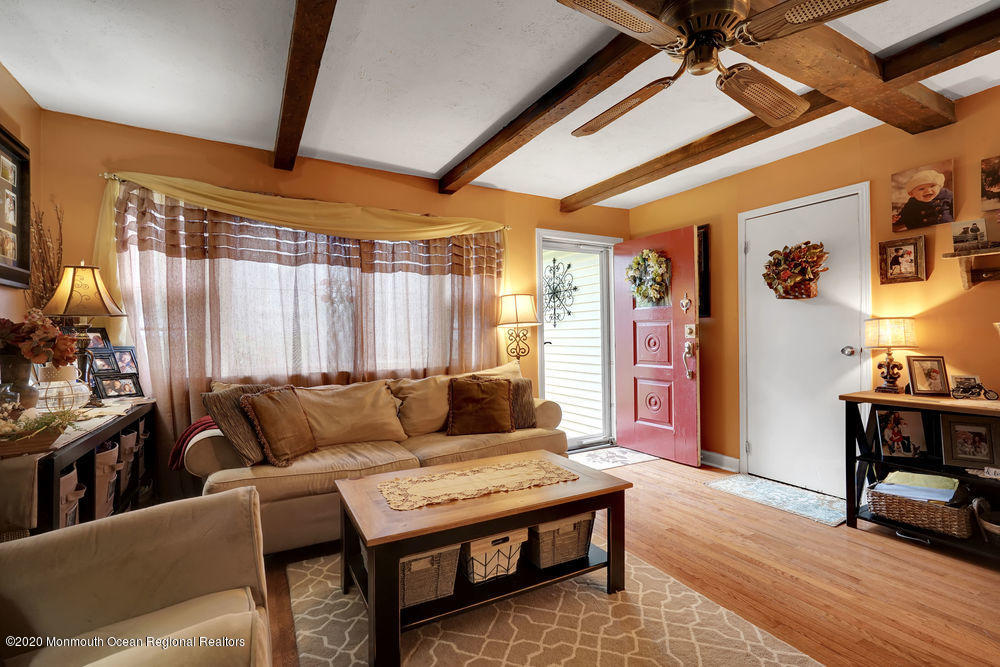 223 Delaware Avenue Oakhurst, NJ 07755 - Photo 4 of 30 a living room with furniture and a wooden floor