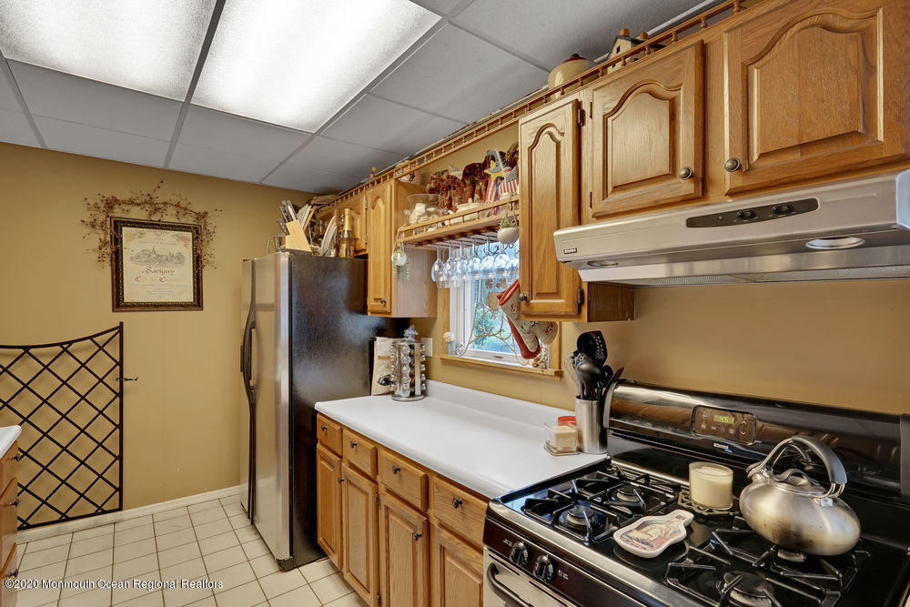 223 Delaware Avenue Oakhurst, NJ 07755 - Photo 7 of 30 a kitchen with a stove and a refrigerator