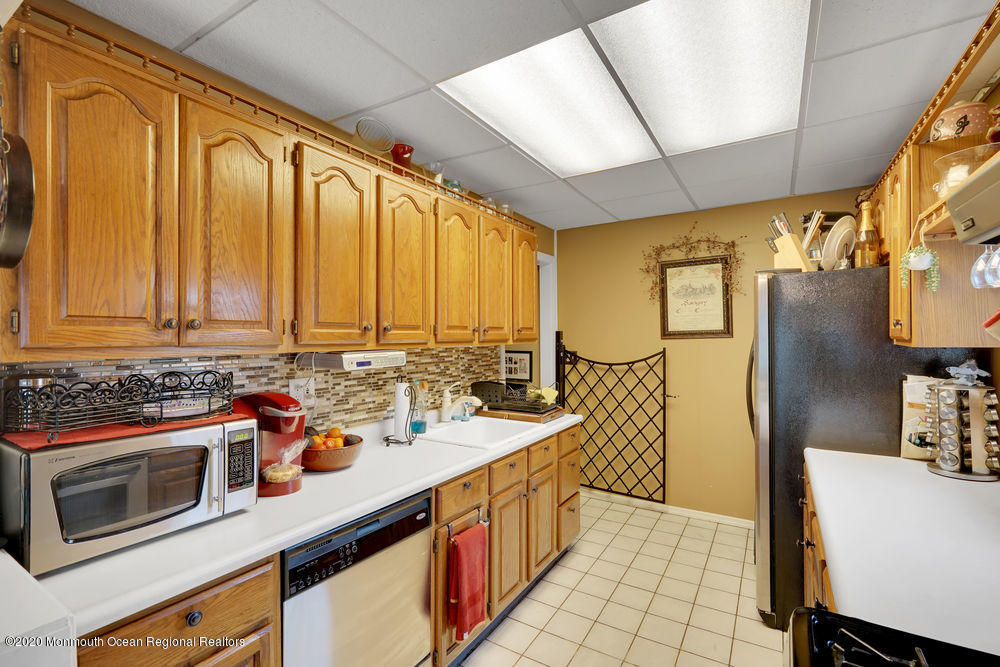 223 Delaware Avenue Oakhurst, NJ 07755 - Photo 8 of 30 a kitchen with stainless steel appliances a sink stove and refrigerator