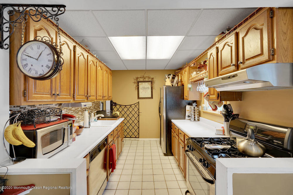 223 Delaware Avenue Oakhurst, NJ 07755 - Photo 9 of 30 a kitchen with stainless steel appliances a stove a sink and a refrigerator