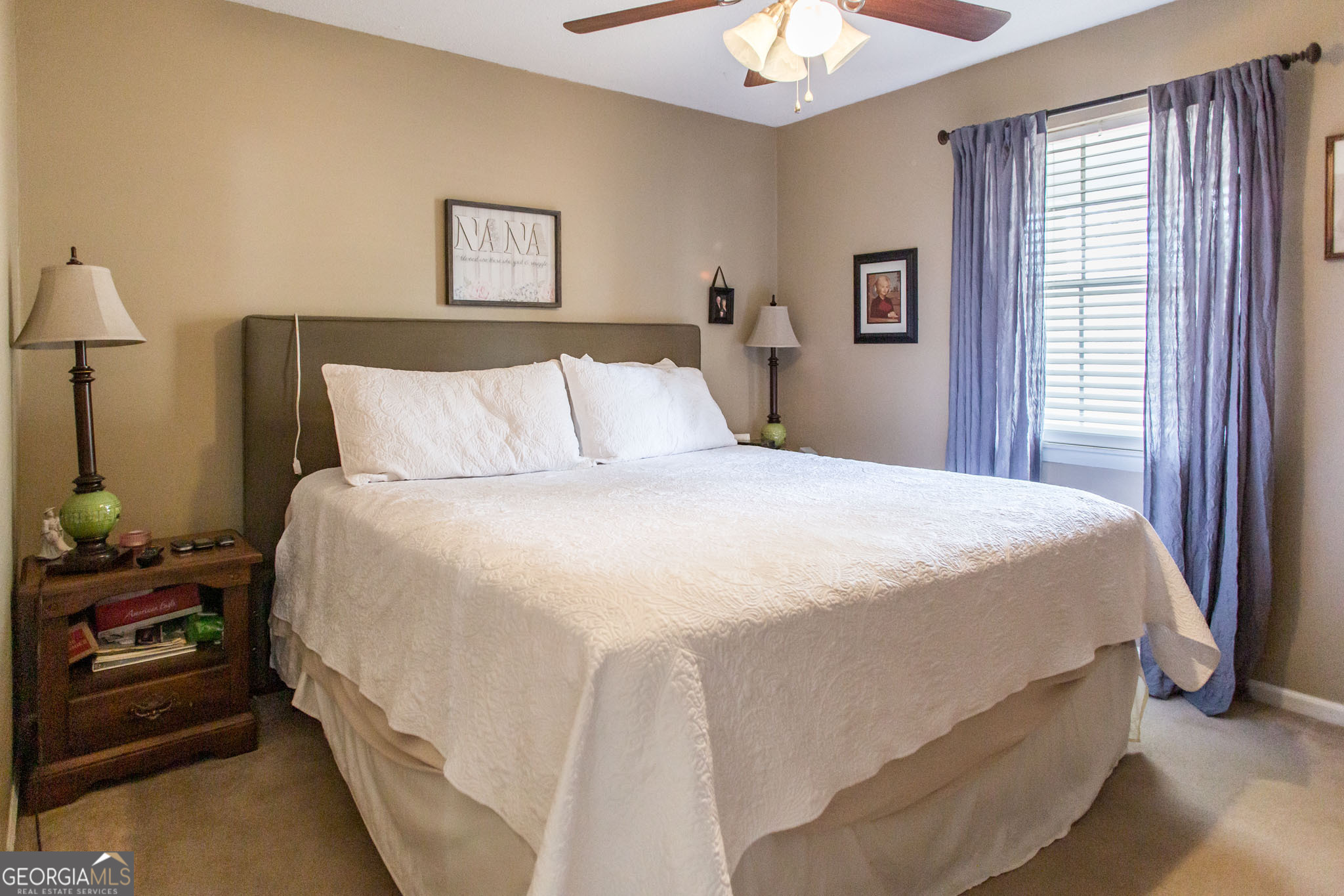 5084 White Hall Church Road Waycross, GA 31503 - Photo 25 of 41 a large bed sitting in a bedroom next to a window and a chandelier