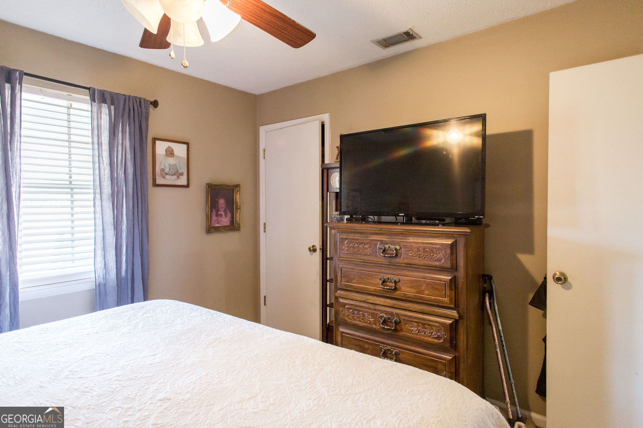 5084 White Hall Church Road Waycross, GA 31503 - Photo 26 of 41 a bedroom with a bed and a flat screen tv