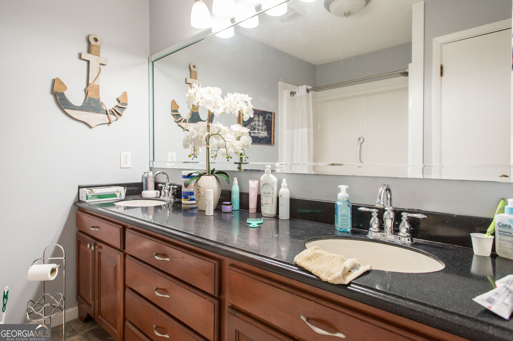 5084 White Hall Church Road Waycross, GA 31503 - Photo 35 of 41 a bathroom with a granite countertop sink a mirror and vanity