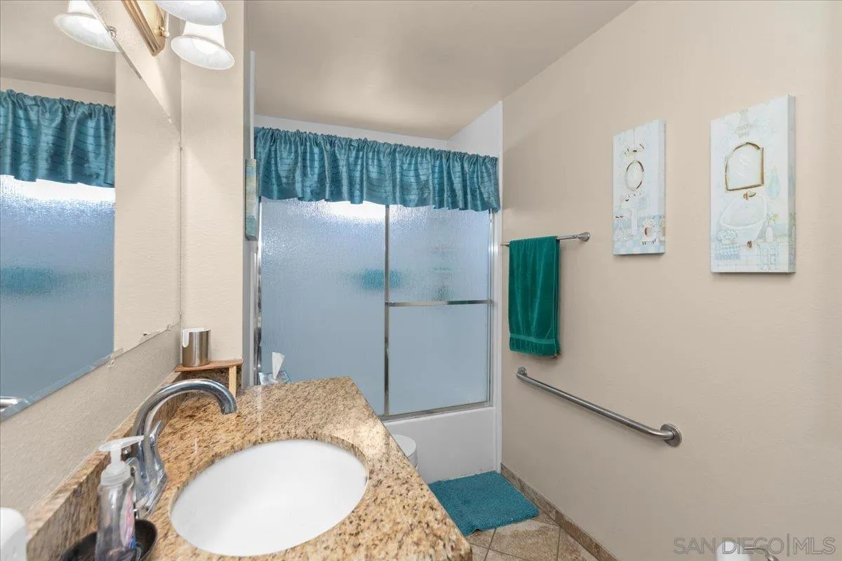 9254 Shadow Hill Road Santee, CA 92071 - Photo 21 of 34 a bathroom with a granite countertop sink and a mirror