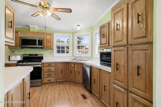 a kitchen with stainless steel appliances a stove microwave and cabinets