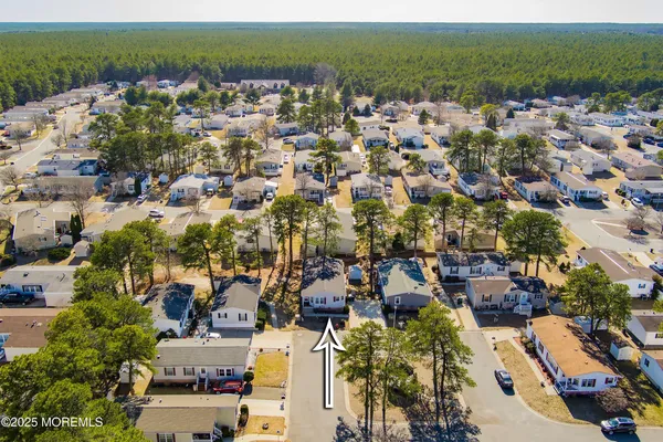 a kitchen with stainless steel appliances granite countertop a white refrigerator a sink dishwasher and a stove with wooden floor