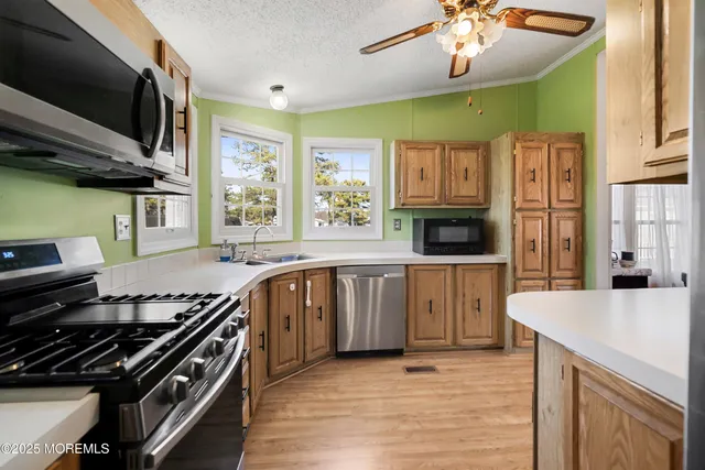 a kitchen with stainless steel appliances granite countertop a stove and a sink