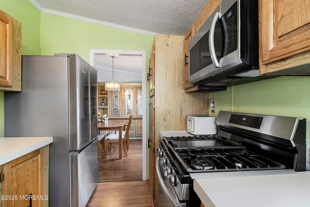 a kitchen with stainless steel appliances granite countertop a stove and a refrigerator