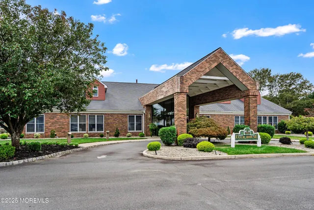 a front view of a house with a yard and outdoor seating