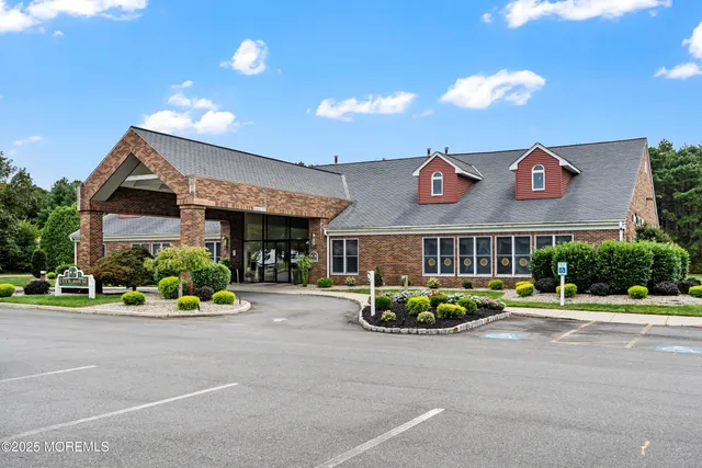 a front view of a building with a garden