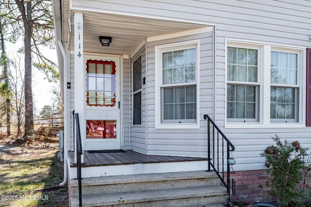 a front view of a house with a street