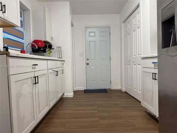 a view of a kitchen from the hallway
