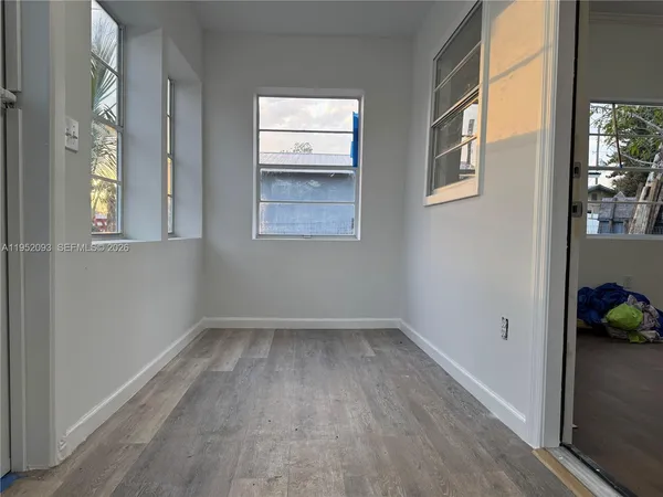 a view of room with window and hardwood floor