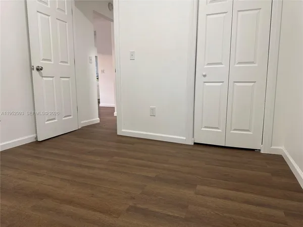a view of wooden floor and closet area