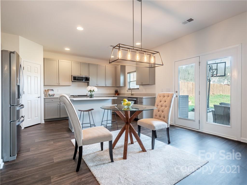 3 Henbit Way Arden, NC 28704 - Photo 21 of 46 a view of kitchen with cabinets table and chairs