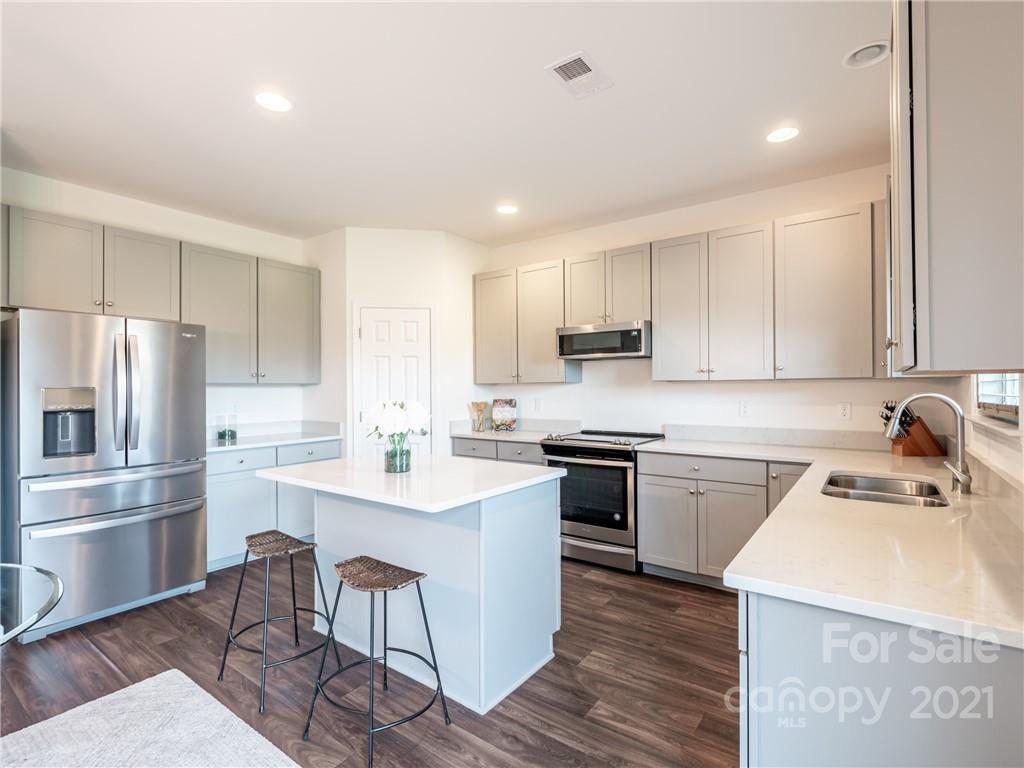 3 Henbit Way Arden, NC 28704 - Photo 24 of 46 a kitchen with a sink a counter top space stainless steel appliances and cabinets