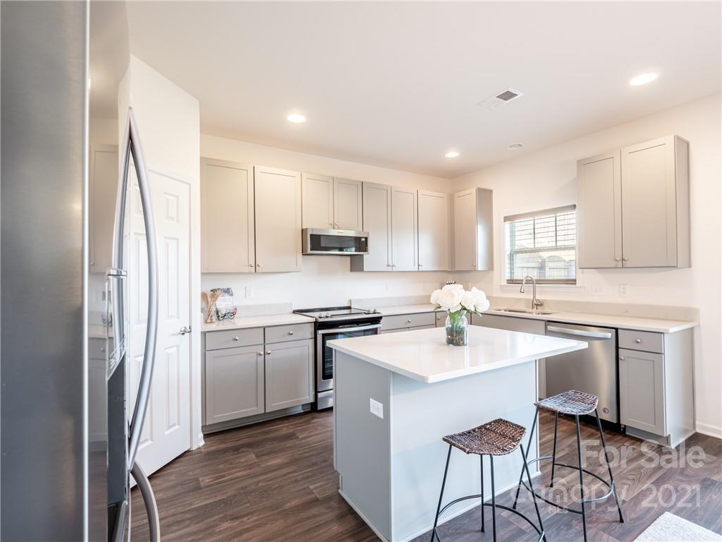 3 Henbit Way Arden, NC 28704 - Photo 25 of 46 a kitchen with white cabinets and white appliances