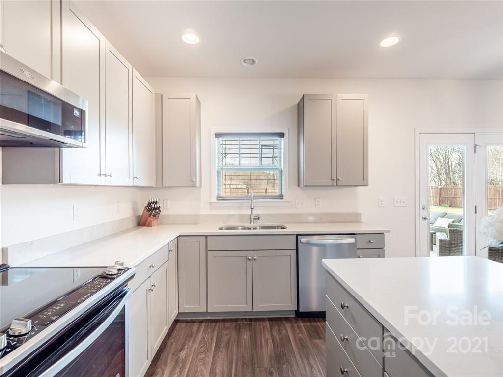 3 Henbit Way Arden, NC 28704 - Photo 26 of 46 a kitchen with a sink stove and cabinets