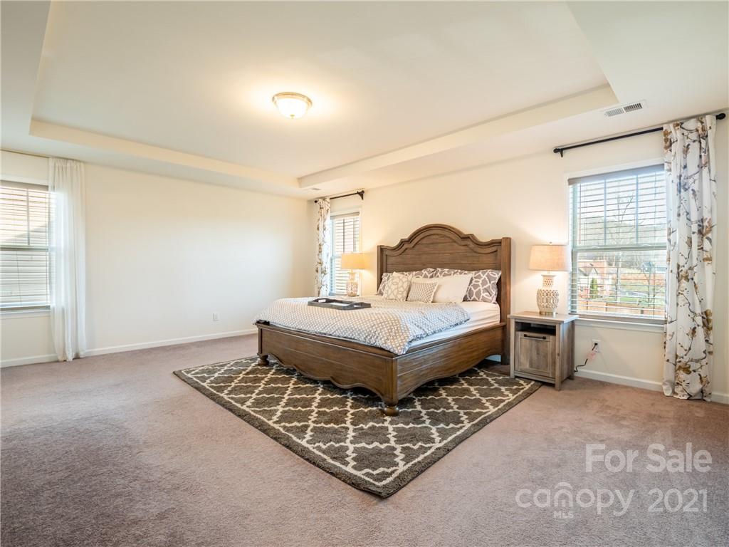 3 Henbit Way Arden, NC 28704 - Photo 30 of 46 a bedroom with a bed and large windows