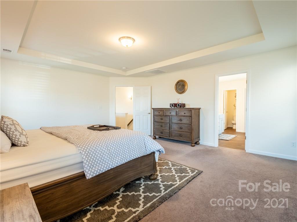 3 Henbit Way Arden, NC 28704 - Photo 31 of 46 a bedroom with a bed and a cabinets