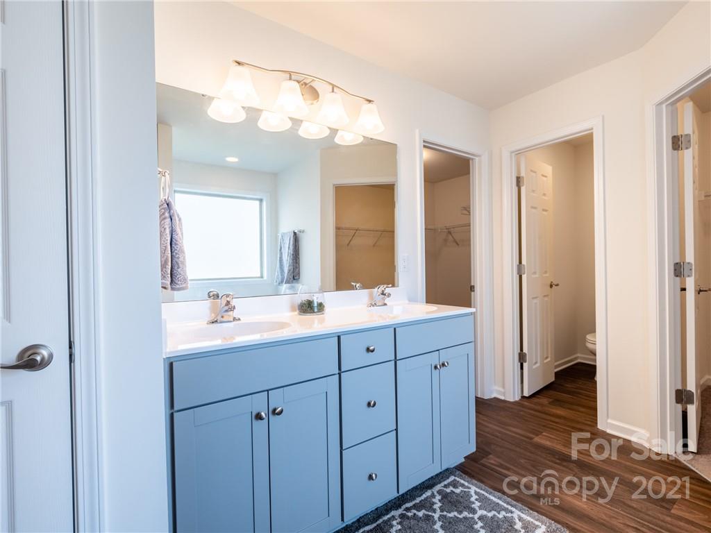3 Henbit Way Arden, NC 28704 - Photo 33 of 46 a bathroom with a double vanity sink and mirror with shower