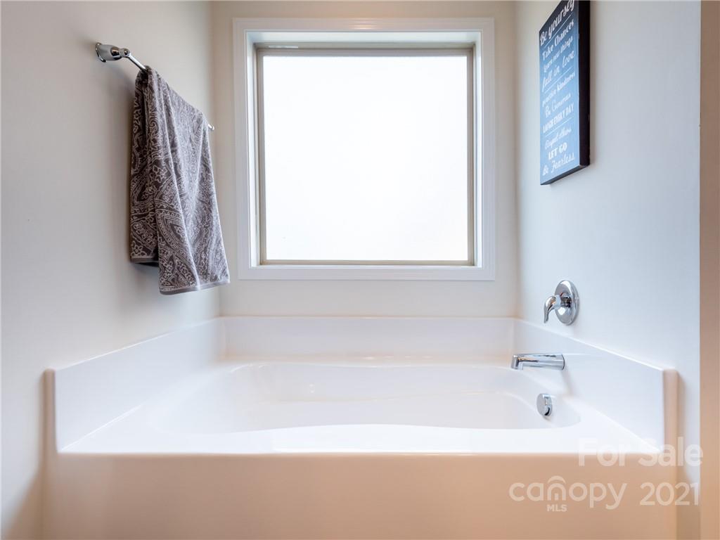3 Henbit Way Arden, NC 28704 - Photo 34 of 46 a bathroom with a bathtub and a shower