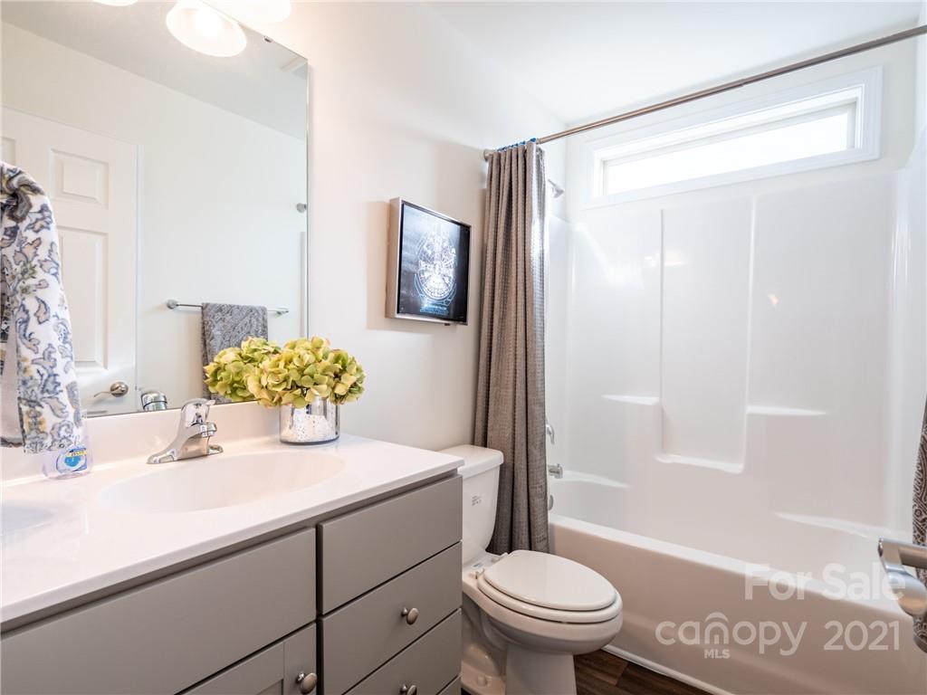 3 Henbit Way Arden, NC 28704 - Photo 39 of 46 a bathroom with a shower sink vanity mirror and toilet