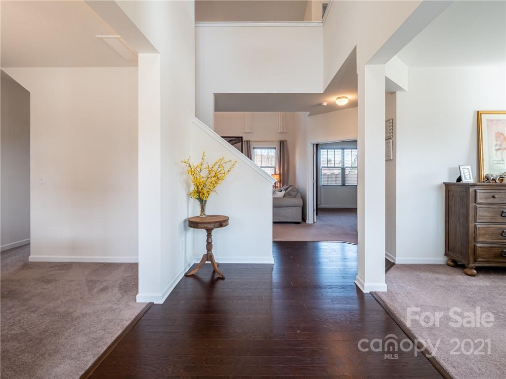 3 Henbit Way Arden, NC 28704 - Photo 7 of 46 a view of a hallway with wooden floor table and chairs