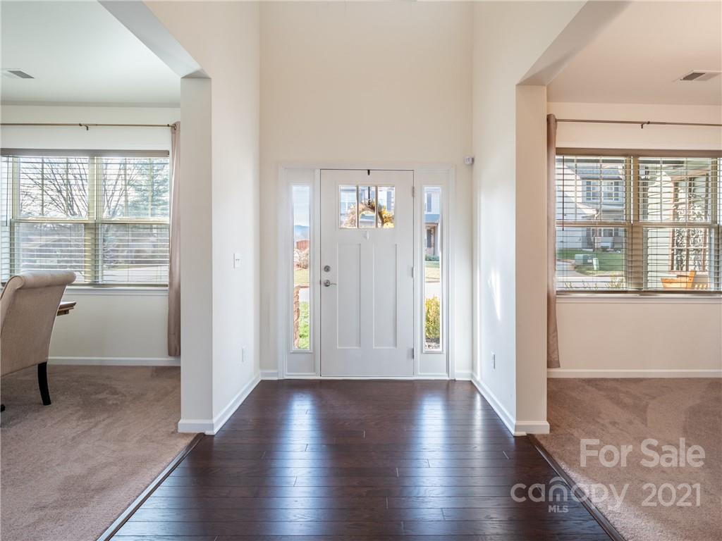 3 Henbit Way Arden, NC 28704 - Photo 8 of 46 a view of a hallway with wooden floor and a window