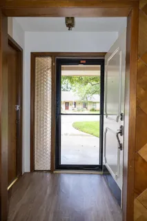 a room with table chairs and wooden floor