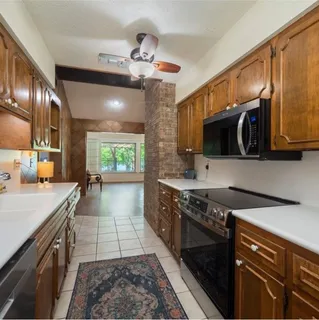 a front view of a house with a garden and yard