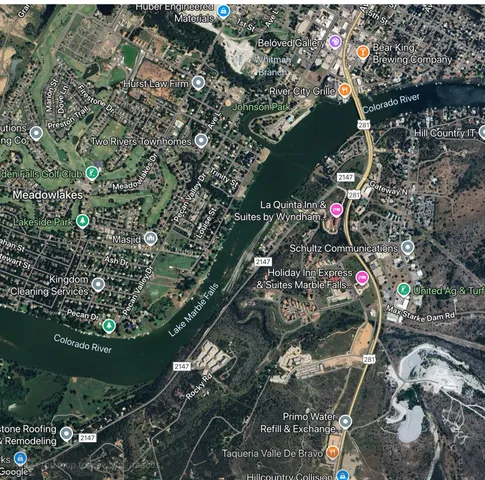 a aerial view of a house with a yard table and chairs