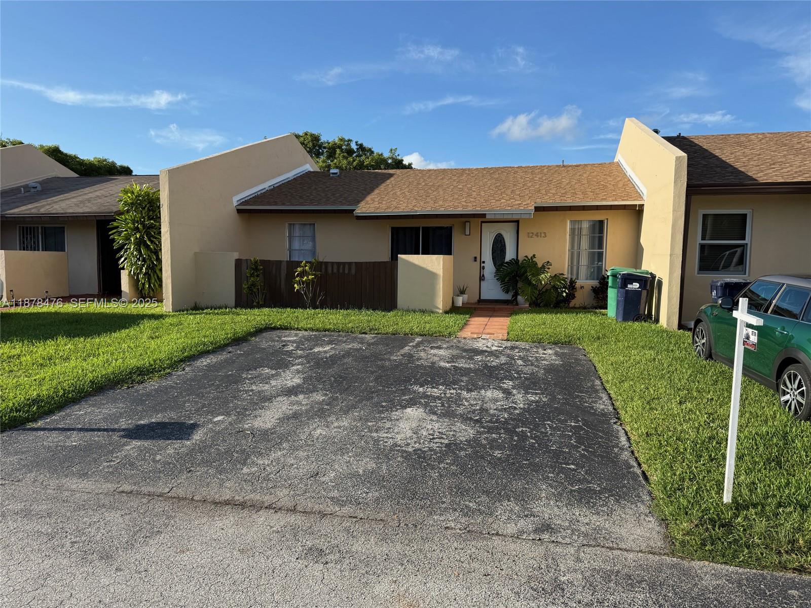 12413 Southwest 112th Terrace Miami, FL 33186 - Photo 1 of 16 a front view of a house with a yard and porch