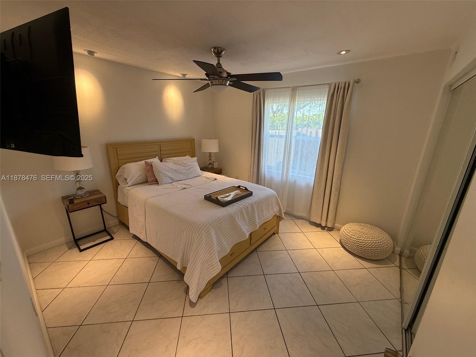 12413 Southwest 112th Terrace Miami, FL 33186 - Photo 12 of 16 a bedroom with a bed and a flat screen tv