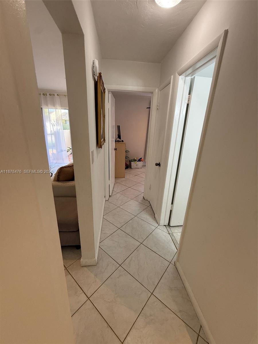 12413 Southwest 112th Terrace Miami, FL 33186 - Photo 13 of 16 a view of a hallway with furniture and a window