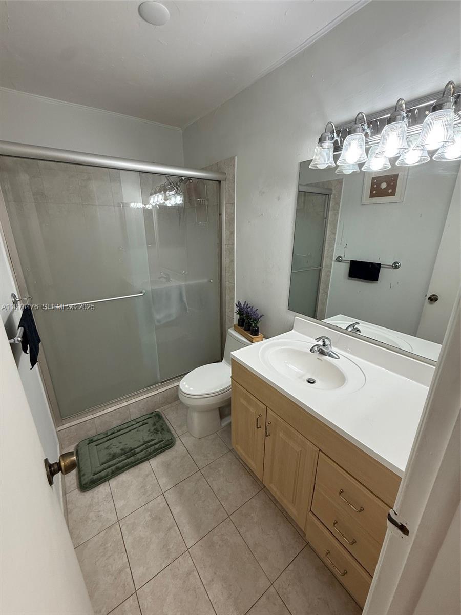 12413 Southwest 112th Terrace Miami, FL 33186 - Photo 14 of 16 a bathroom with a sink mirror and toilet