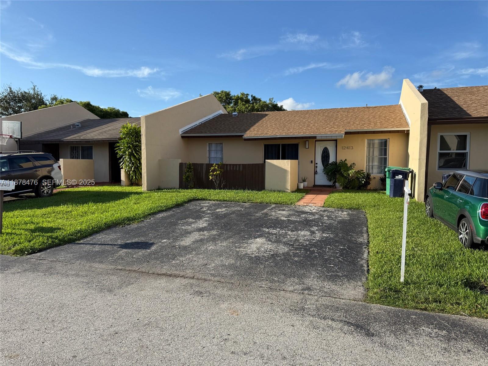 12413 Southwest 112th Terrace Miami, FL 33186 - Photo 2 of 16 a front view of a house with a yard and garage