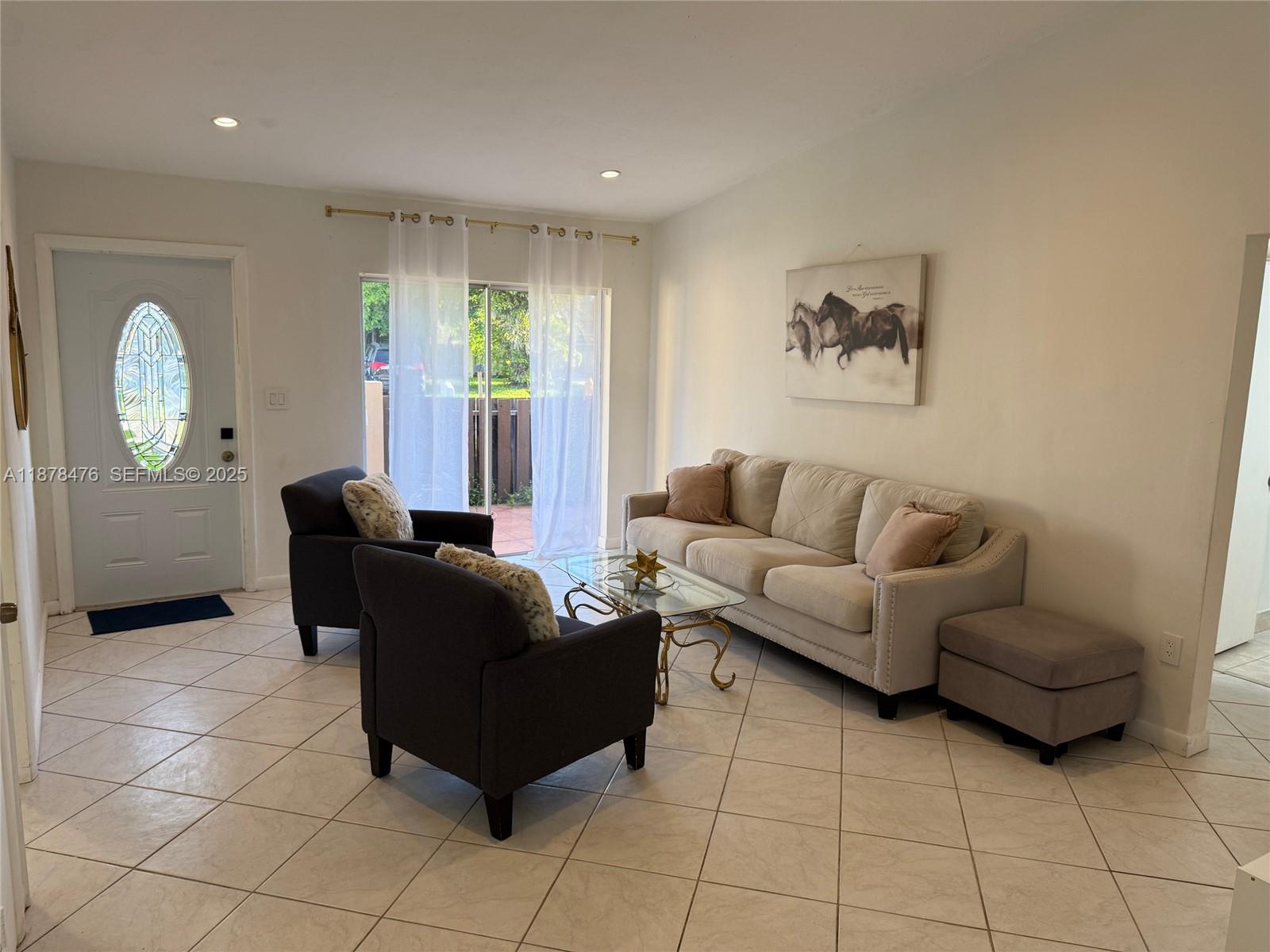 12413 Southwest 112th Terrace Miami, FL 33186 - Photo 3 of 16 a living room with furniture and a window