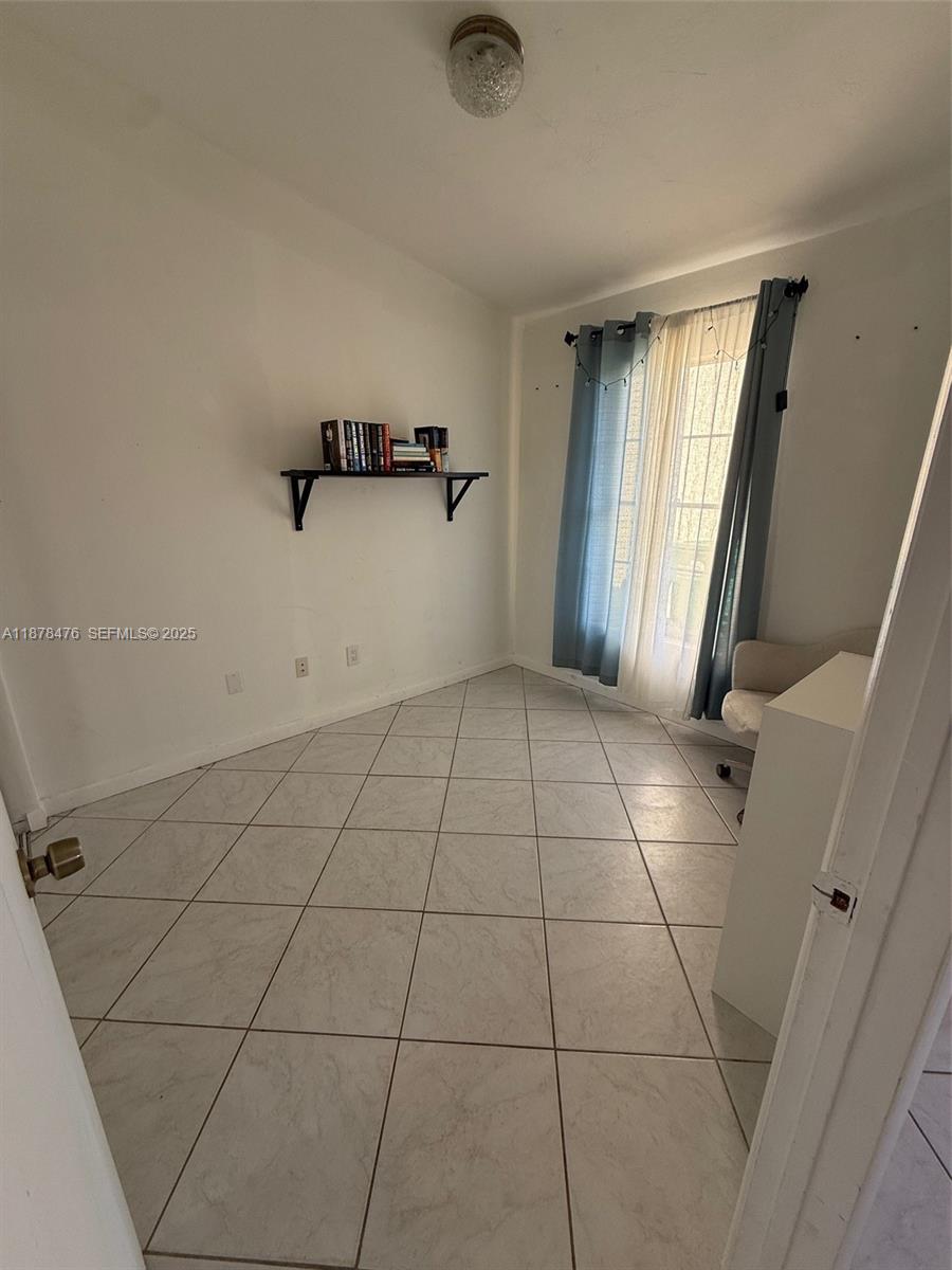 12413 Southwest 112th Terrace Miami, FL 33186 - Photo 7 of 16 a view of an empty room with a window