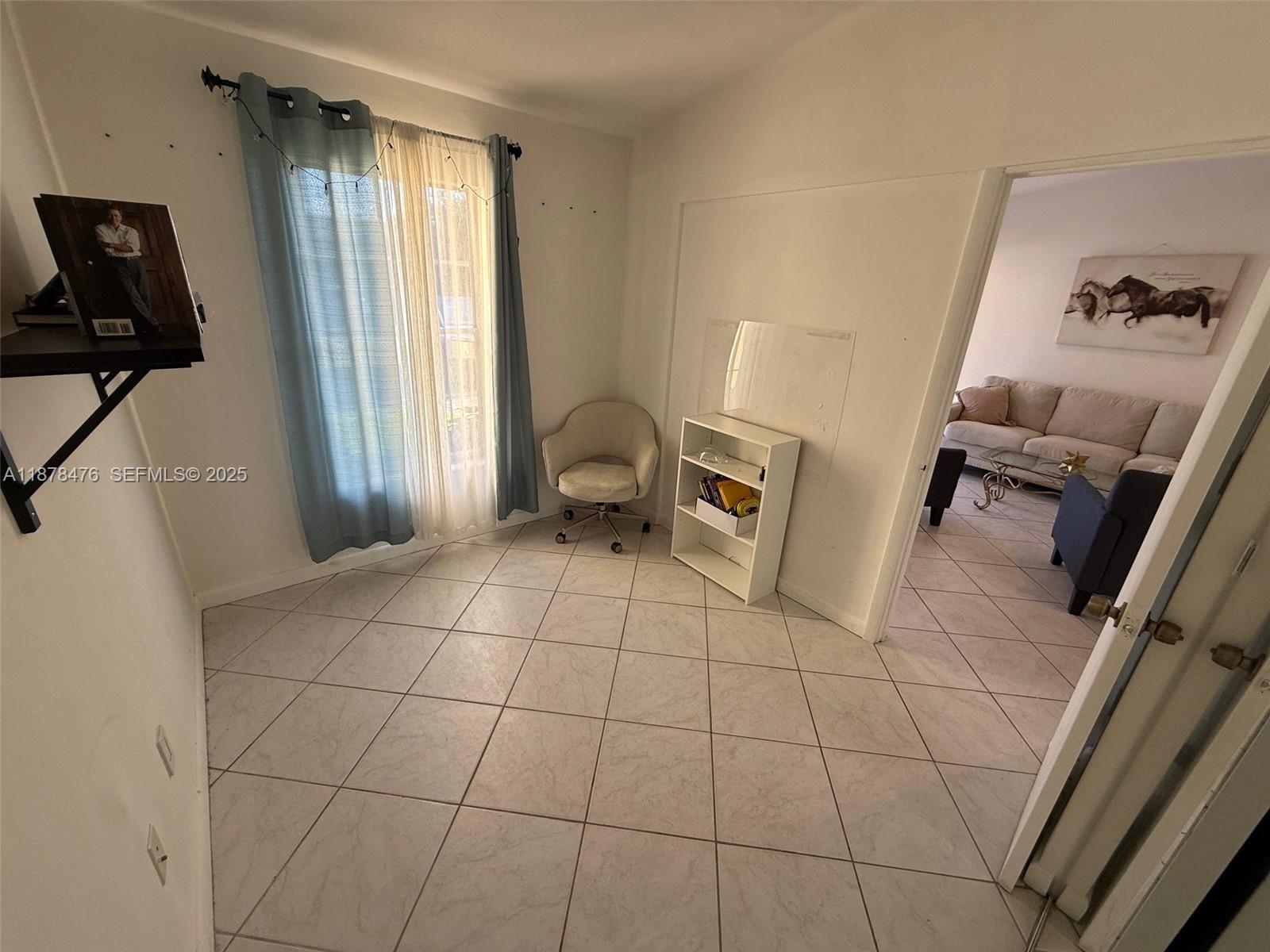 12413 Southwest 112th Terrace Miami, FL 33186 - Photo 8 of 16 a view of an empty room with a window