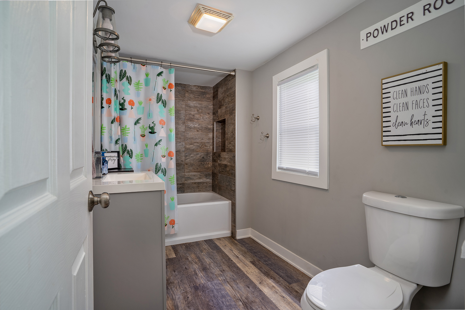 27 Arlington Road Fox Lake, IL 60020 - Photo 12 of 17 a white toilet sitting next to a bathroom sink and tub