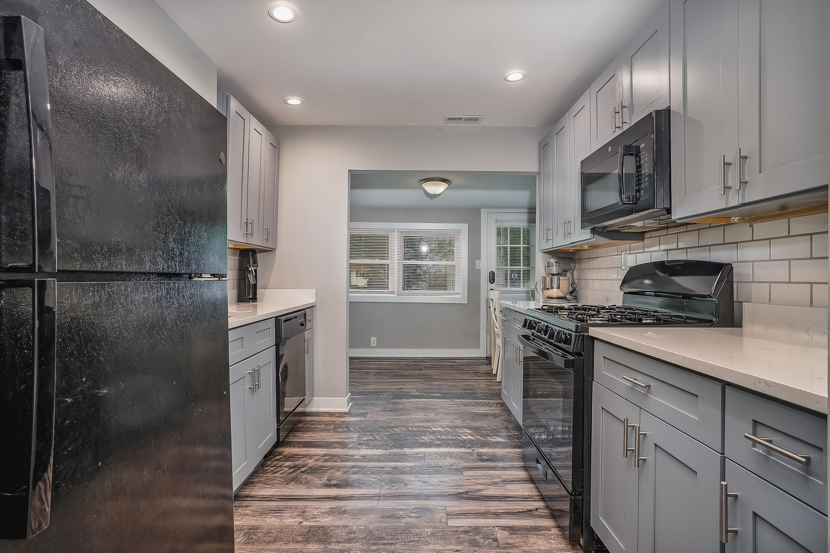 27 Arlington Road Fox Lake, IL 60020 - Photo 7 of 17 a kitchen with stainless steel appliances granite countertop a stove a refrigerator and a sink