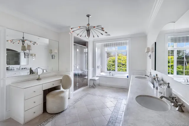 a spacious bathroom with a granite countertop sink mirror and a bathtub