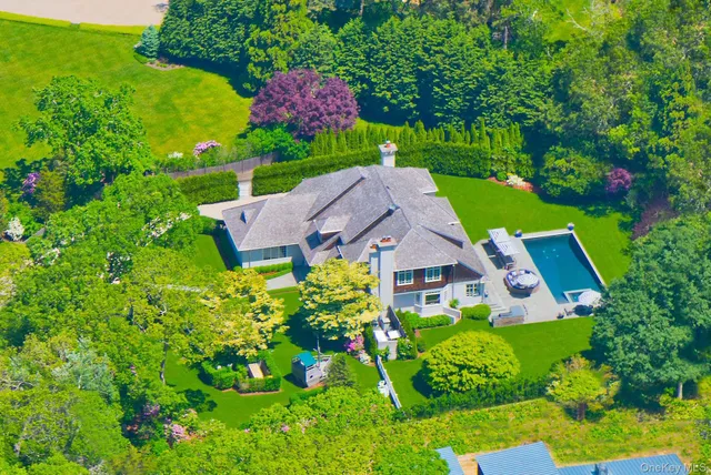 an aerial view of a house with garden space and a street view