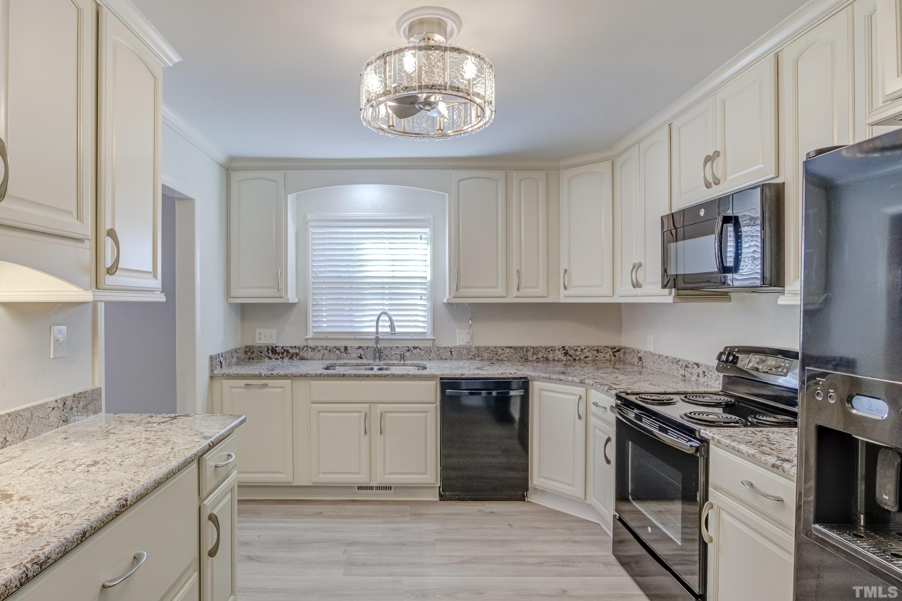100 Wythe Circle Raleigh, NC 27615 - Photo 14 of 46 Newer cabinets, Bianco Antico Granite countertops, "Fandelier" light fixture